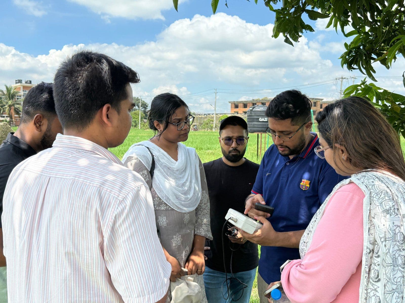 Reviewing rice field test results and applications at the Bangladesh Agriculture Research Institute.